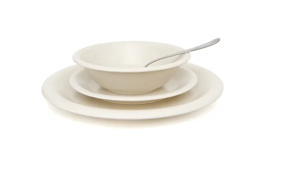 Plain beige plates with spoon isolated — Stock Photo, Image