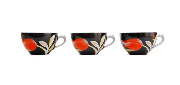 Fila di tre tazze di tè nero isolato — Foto Stock