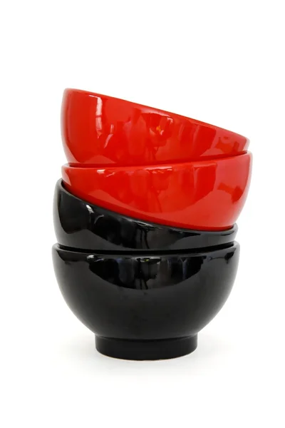 Zigzag stack of red and two black bowls — Stock Photo, Image