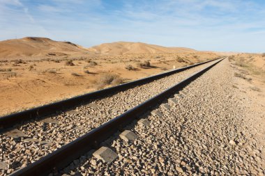 Straight railway in desert to horizon clipart