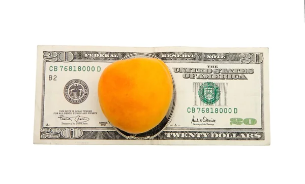 Fresh yellow apricot on dollar bill — Stock Photo, Image