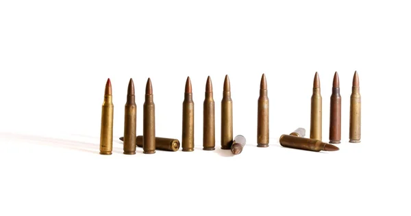 Row of M16 cartridges with some fallen — Stock Photo, Image