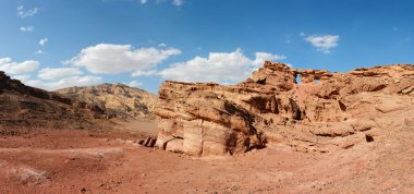 Scenic weathered orange rock in desert clipart