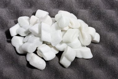 A heap of white shipping foam on black clipart
