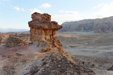 Rocky desert landscape at sunset clipart