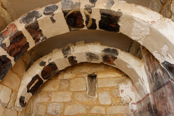 Ancient stone arches with fresco remains