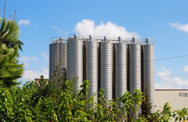 Twelve tower silos on chemical plant clipart