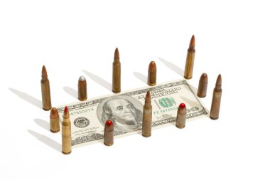 Hundred dollar bill fenced by cartridges clipart