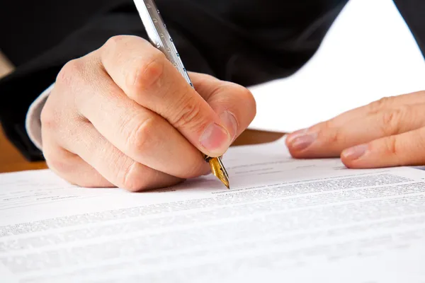 Close up on a businessman hands signing — Stock Photo, Image