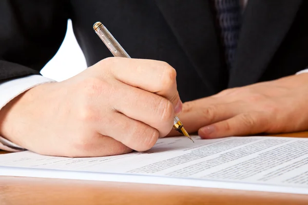 Close up on a businessman hands signing Stock Photo