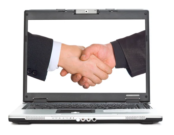 Handshake na obrazovce přenosného počítače — Stock fotografie