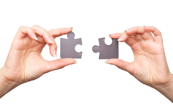 Hands with two puzzles — Stock Photo, Image