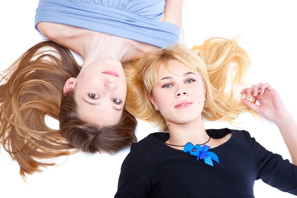 Two girls is lying on a floor. Isolated — Stock Photo, Image