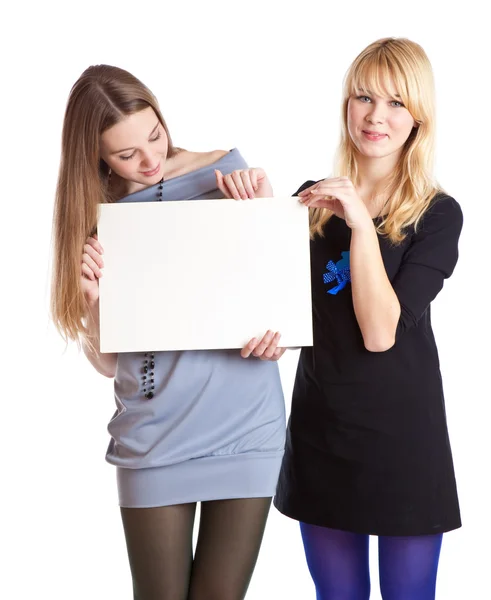 Two teenage girls with card for text — Stock Photo, Image