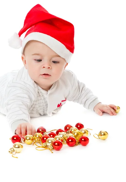 Kleiner Junge mit Weihnachtsmütze und Spielzeug — Stockfoto