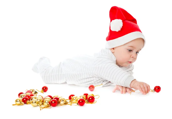 Kleiner Junge mit Weihnachtsmütze und Spielzeug — Stockfoto