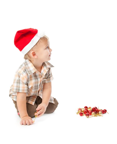 Mały chłopiec ubrany kapelusz santa i playi — Zdjęcie stockowe