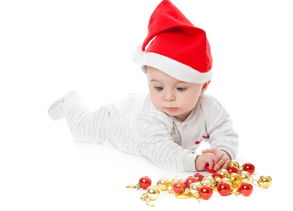 Kleine jongen dragen een kerstmuts en playi — Stockfoto
