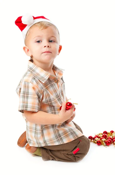 Petit garçon portant un chapeau de Père Noël et playi — Photo
