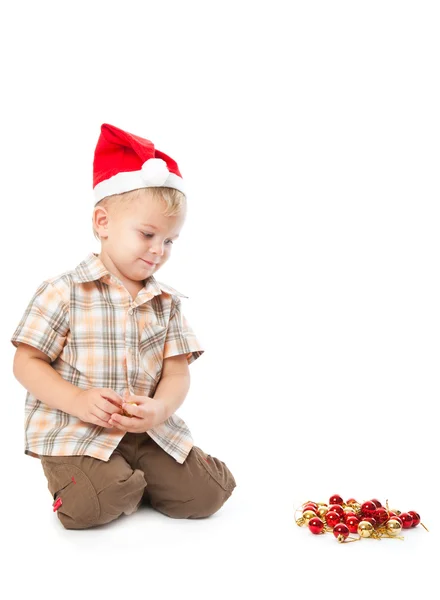 小男孩穿上圣诞老人的帽子和 playi — 图库照片