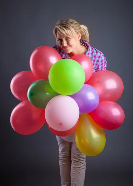 Young girl holding balloons — Stock Photo, Image