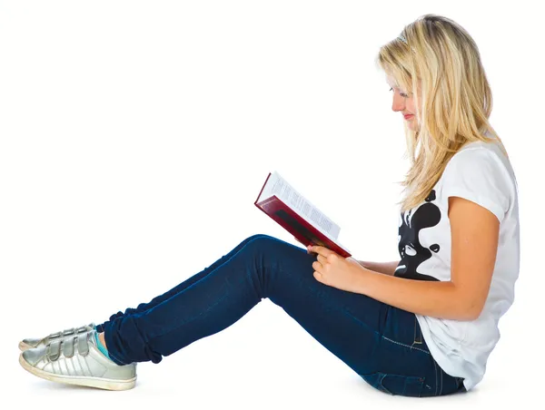 床に女の子は本を読んでください。 — ストック写真