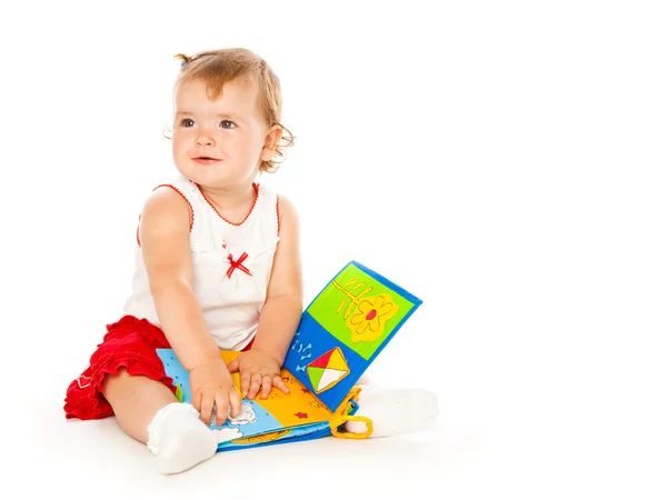 Kis lány játék wit könyv — Stock Fotó