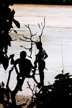 Boys playing at Mekong river clipart