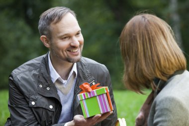 Man holding gift box clipart