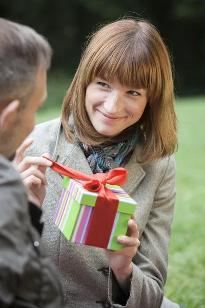 Woman opens a gift box — Stock Photo, Image