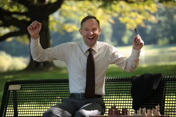 Happy businessman playing chess — Stock Photo, Image