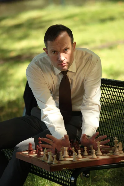 Angry man playing chess — Stock Photo, Image