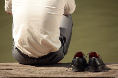 Man sitting at the pier clipart