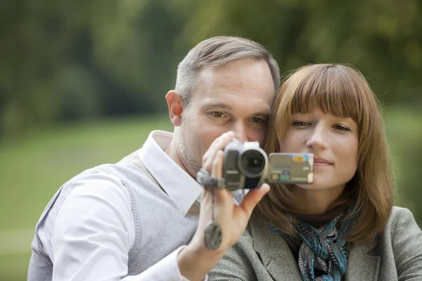 Couple with video camera filming — Stock Photo, Image