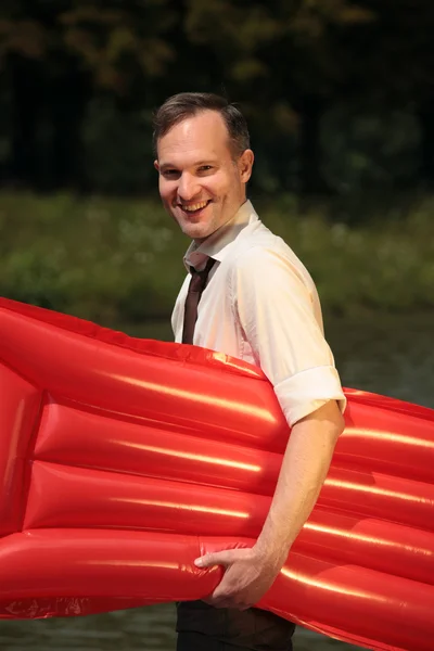 Happy man with air mattress — Stock Photo, Image