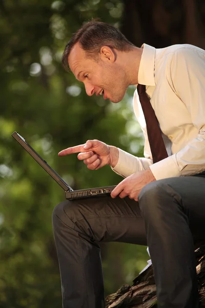 Pointing with finger at laptop — Stock Photo, Image
