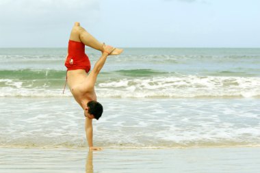 Handstand on the beach clipart