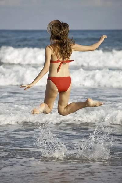 Donna che salta sulla spiaggia — Foto Stock
