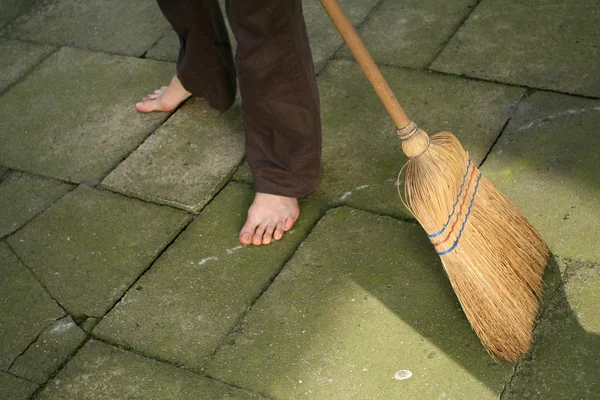 Sweeping with broomstick — Stock Photo, Image