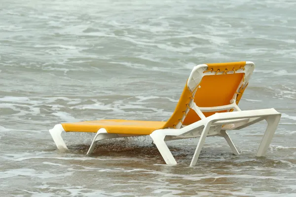 Chaise longue in water — Stock Photo, Image