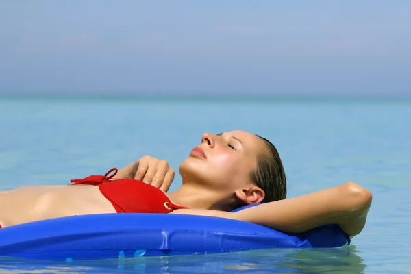 Woman relaxing on an air mattress Stock Image