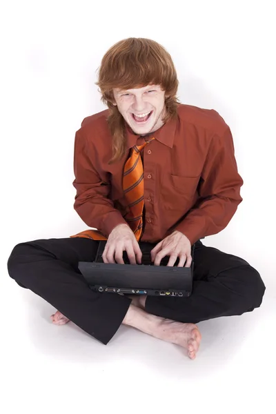 Uomo d'affari ridente con computer portatile — Foto Stock