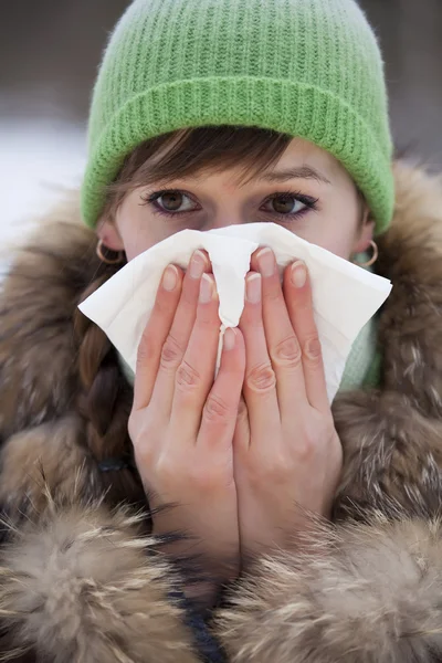 Woman sneezing in handkerchief — Stock Photo, Image