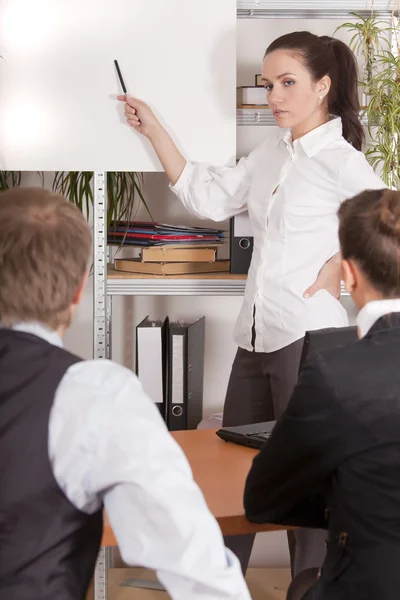 Woman talks to audience in office — Stock Photo, Image