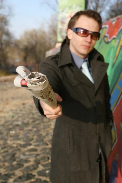 Holding newspaper in camera — Stock Photo, Image