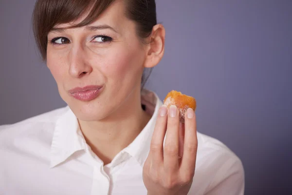 Женщина ест сахарный пирог — стоковое фото