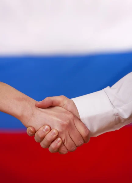 Aperto de mão sobre a bandeira russa — Fotografia de Stock