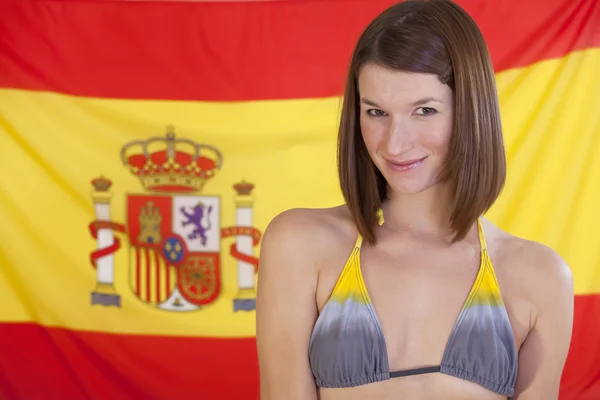 Женщина над испанским флагом — стоковое фото