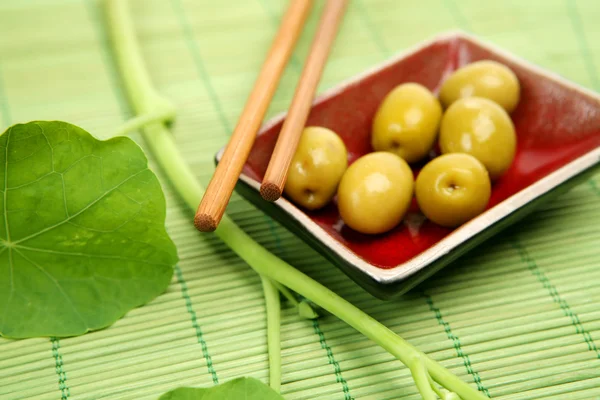 Olives and wooden sticks — Stock Photo, Image
