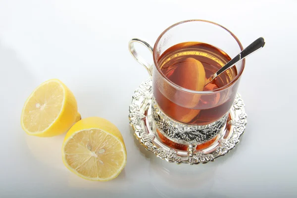 Tea in glass mug and lemons — Stock Photo, Image